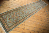 High-angle view of the vintage Tabriz runner, showing its full length and delicate vinery on a powder blue field.