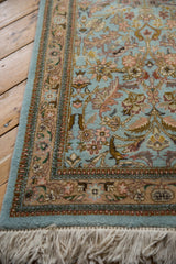 Corner of a vintage Tabriz runner highlighting the plush pile, floral border, and intact cotton fringe.