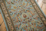 Close view of the vintage Tabriz runner's full pile with delicate vinery and floral details.