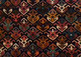 Repeating geometric floral blossoms in a lattice design showing the rug's full, plush pile.