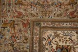 Intricate corner of a Persian Tabriz carpet showing the pictorial hunting scene and ivory border.