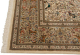 Corner view of a Persian Tabriz carpet highlighting the intricate pictorial hunting scene border and ivory fringe.
