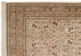 Intricate hunting scene border and ivory fringe on the corner of a vintage Tabriz Persian carpet.