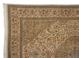 Corner of a vintage Tabriz carpet showing elaborate floral borders and original ivory fringe.