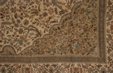 Detailed corner of a vintage Persian Tabriz rug showing floral tree motifs beside the scalloped medallion.