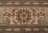 Splayed palmette and bird motifs in dusty terracotta and blue on a vintage Tabriz rug.
