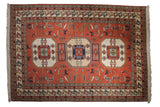 Terracotta vintage Persian Meshkin carpet with ivory triple medallions, bird motifs, and finned borders, 10'5
