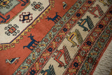 Vintage Meshkin carpet border showcasing layered finned birds and off-white fringe.