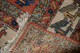 Vintage Meshkin carpet corner showing terracotta, ivory, blue bird motifs, fringe, and intact selvage.