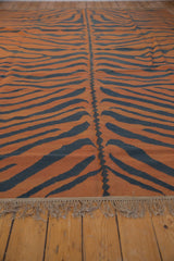 Vintage Indian Tiger Kilim rug in pale rust and charcoal stripes, with central design and natural fringe.