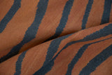 Hand-woven texture of a vintage Indian Tiger Kilim with rust and charcoal abrashes.
