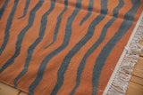 Vintage Indian Kilim rug showing white fringe, side selvage, and rust charcoal stripes.