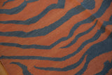 Hand-woven Indian kilim featuring abstract pale rust and charcoal tiger stripes.