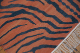 Hand woven Vintage Indian Tiger Kilim rug with burnt orange and charcoal stripes, white fringe.