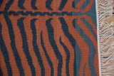Hand woven Indian Tiger Kilim's terracotta and charcoal stripes, with secure white fringe.