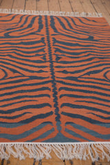 Hand woven Indian Tiger Kilim rug detail showing rust and charcoal tiger stripes with fringe.