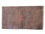 A vintage Lavar Kerman carpet with a detailed millefleur design in cochineal red, sapphire blue, and ivory.
