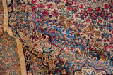 Plush pile of a Lavar Kerman showing flowing Rococo details in sapphire blue and ruby red.