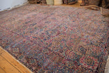 Expansive view of the vintage Lavar Kerman carpet's detailed millefleur design and natural dye colors.