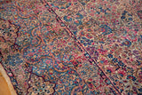 Intricate millefleur design with flowing Rococo contours in cochineal red and sapphire blue.