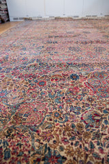 Low perspective across the intricate millefleur design and scrolling contours of a Lavar Kerman carpet.