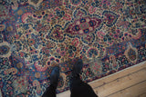 Dramatic center medallion and milfleur field of a vintage Lavar Kerman rug; ivory, navy, cochineal, blush.