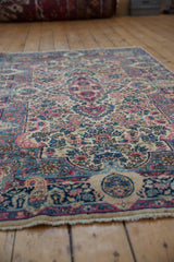 Vintage Lavar Kerman rug milfleur field with ivory, navy, blush, cochineal, and gold florals.