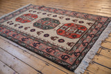 Vintage Meshkin rug detail: rust gul medallion, finned peacocks, and bird border.
