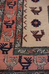 Rust and ivory geometric finned peacocks with alternating birds on a vintage Meshkin rug.