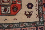 Vintage Meshkin rug section: ivory field, rust gul outline, finned peacock, blush border birds.