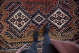 Hand-knotted pile of vintage Afshar rug, revealing geometric floral botehs in madder and navy.