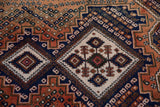 Vintage Afshar rug's diamond contour medallion, rich with beige, navy, and terracotta geometric patterns.