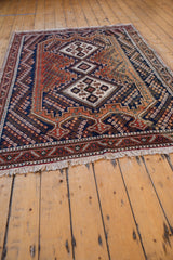 Vintage Afshar rug's white fringe and re-done selvage with geometric red and navy border.