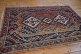 Vintage Afshar rug corner with hand-knotted fringe and re-done madder red selvage.