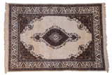 Vintage Tabriz carpet with a brown medallion and spandrels on a natural, undyed wool field.