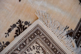 Intact side cord selvage and secured ivory fringe on a vintage hand-knotted Tabriz carpet.