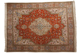 Vintage Tabatabaie Tabriz carpet, burnt orange floral field, central medallion, book-cover motif.