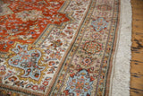 Vintage Tabriz rug border with rust, ivory, powder blue floral patterns and fringe.