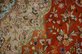 Vintage Tabriz rug detail: burnt orange and beige fields with powder blue floral vinery.