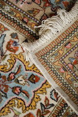 Ivory fringe, powder blue and gold floral patterns, with geometric Tabriz borders.