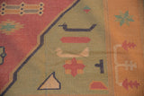 Hand woven geometric bird and block patterns in dusty seafoam and raspberry red dhurrie.