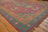 Hand woven dhurrie carpet fringe with geometric seafoam and raspberry borders.