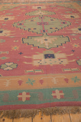 Hand woven Dhurrie carpet fringe, featuring pale raspberry and dusty seafoam geometric border.