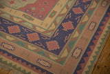 Navy royal blue border with raspberry and olive geometric patterns on a vintage Dhurrie.