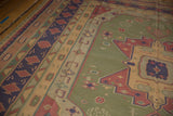 Primitively drawn geometric motifs in olive, navy, and raspberry on vintage Dhurrie rug.