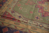 Vintage stone wash dhurrie close-up with geometric and checkered motifs in olive green, dusty red, navy.