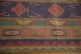 Geometric motifs on vintage Stone Wash Dhurrie rug in muted navy, olive, and dusty red.