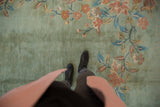 Soft, plush pale green pile of a Japanese Art Deco carpet with floral vines.
