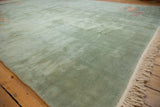Soft seafoam green plush pile and ivory fringe of a vintage Art Deco carpet.