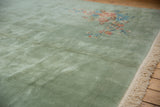 Plush seafoam green pile, ornate blush floral vines, and ivory fringe of a Japanese Art Deco carpet.